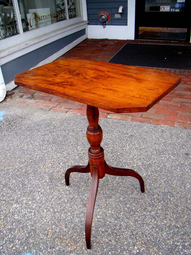 An early 19th century New England cherry and maple tilt-top candle stand circa 1820